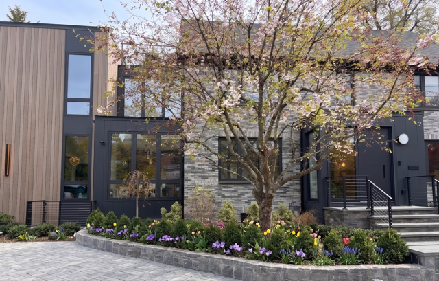 Modern contemporary townhouse with stone facade and spring landscaping built by Chilton Development